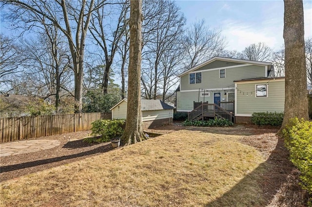 rear view of property with a yard and a deck