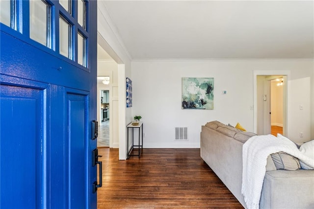 foyer with crown molding and dark hardwood / wood-style floors