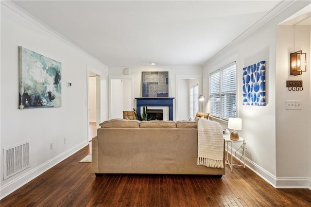 living room with dark wood-type flooring and ornamental molding