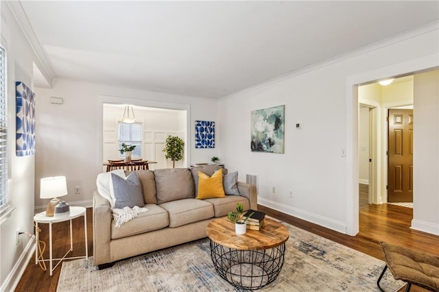 living room with hardwood / wood-style flooring and crown molding