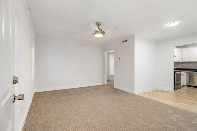 unfurnished living room with light carpet, crown molding, and a ceiling fan