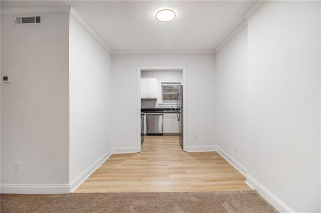 hall featuring visible vents, baseboards, and crown molding