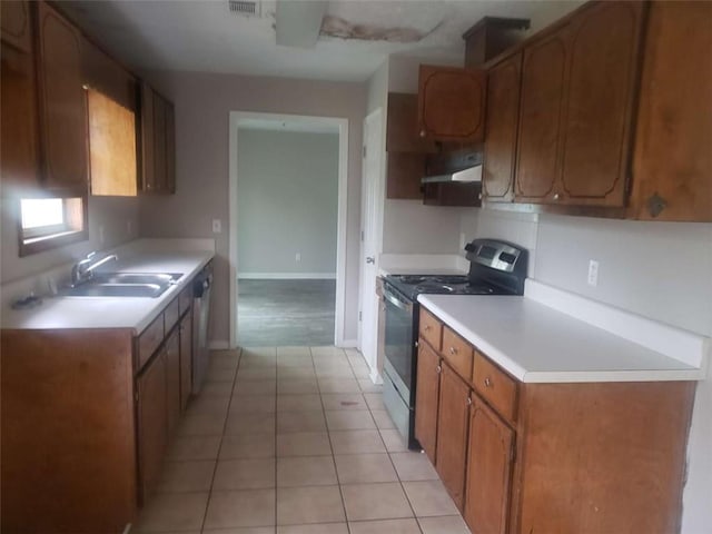 kitchen with under cabinet range hood, stainless steel appliances, a sink, light countertops, and brown cabinetry