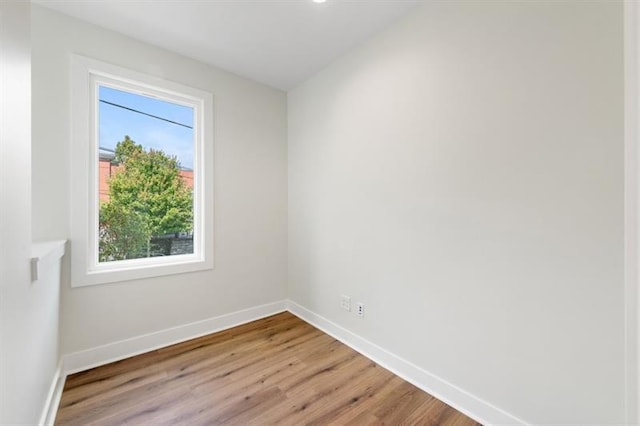 spare room with wood-type flooring