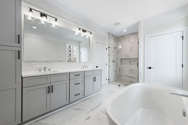 bathroom featuring vanity and separate shower and tub