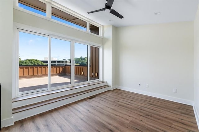 empty room featuring hardwood / wood-style floors and ceiling fan