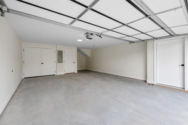 garage with electric panel and a garage door opener