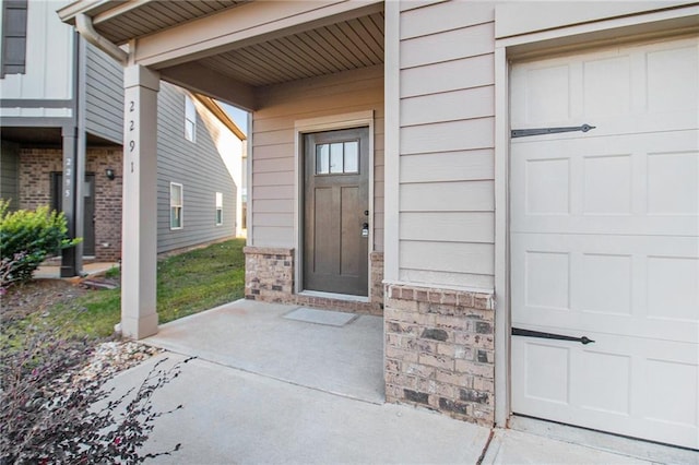 2291 Elise Way, Hampton, GA 30228 - property entrance with a garage and brick siding