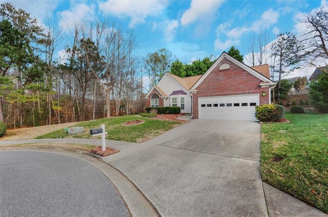 view of front of property featuring a front yard and a garage