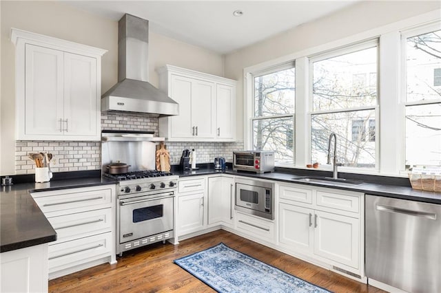 9129 Selborne Ln, Chattahoochee Hills, GA 30268 - kitchen with backsplash, wall chimney range hood, sink, white cabinetry, and stainless steel appliances