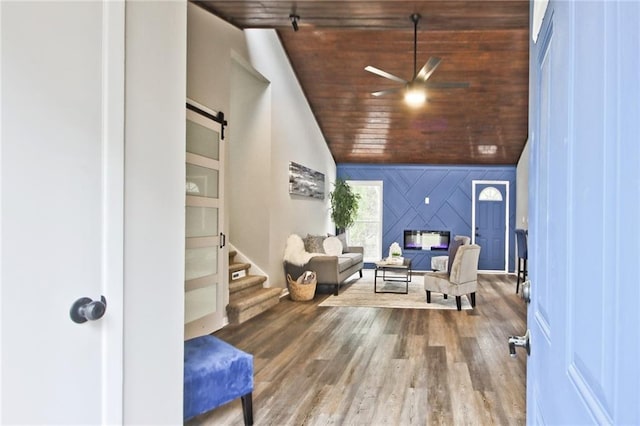783 Lost Creek Cir, Stone Mountain, GA 30088 - living room featuring a barn door, wooden ceiling, lofted ceiling, wood finished floors, and ceiling fan