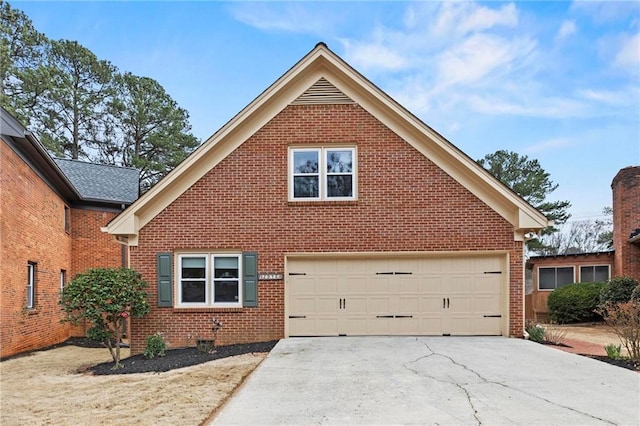 traditional home with a garage, concrete driveway, and brick siding