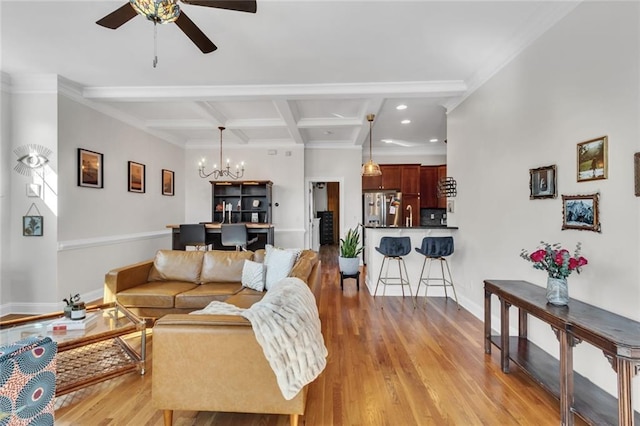 living area with beam ceiling, light wood-style floors, coffered ceiling, baseboards, and ceiling fan with notable chandelier