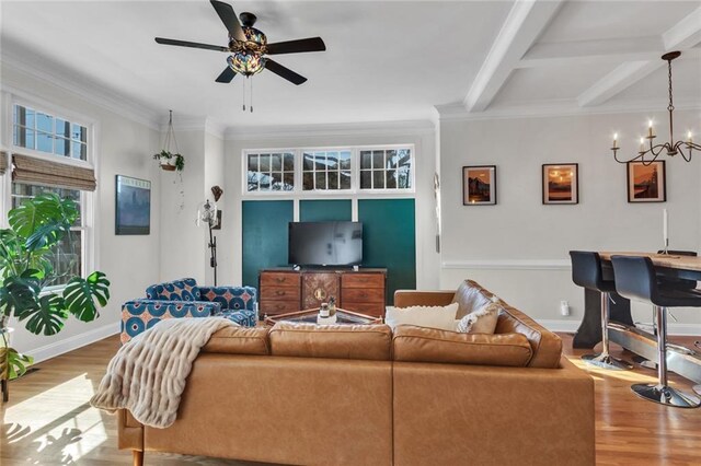 living area with ornamental molding, beamed ceiling, baseboards, and wood finished floors