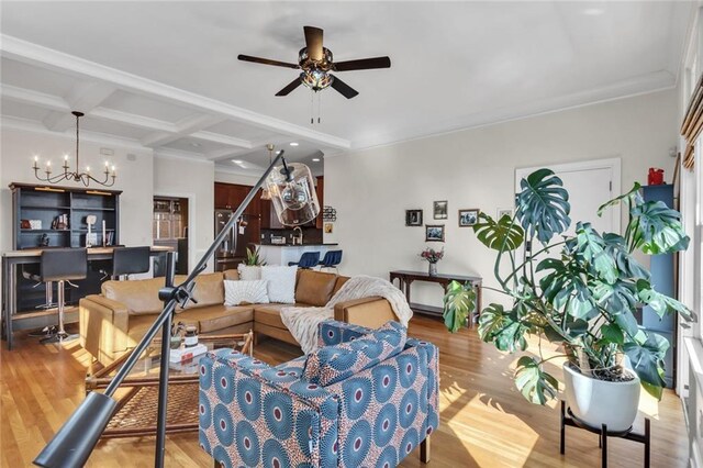 living area with stairs, light wood-style floors, coffered ceiling, beamed ceiling, and ceiling fan with notable chandelier