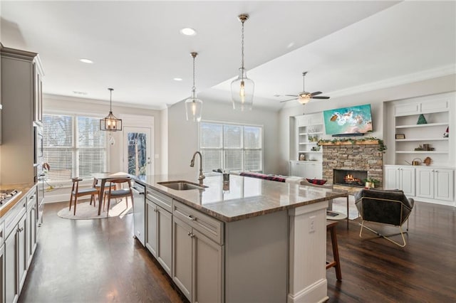 kitchen featuring dark wood-style floors, crown molding, gray cabinets, stainless steel dishwasher, and a sink