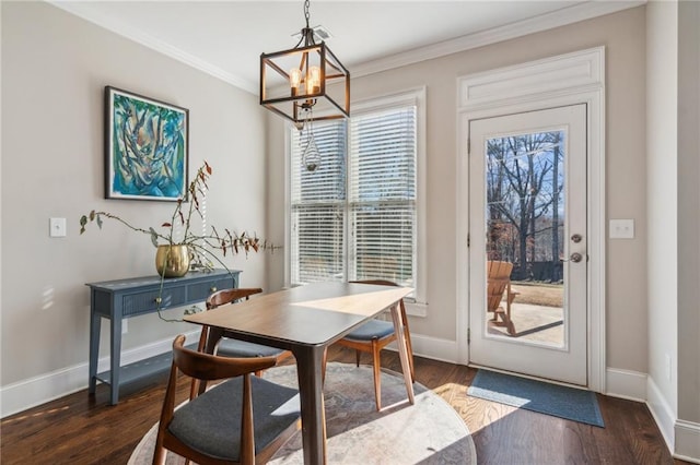 dining room featuring dark wood-style floors, baseboards, and crown molding