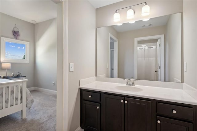 bathroom with visible vents, vanity, and baseboards