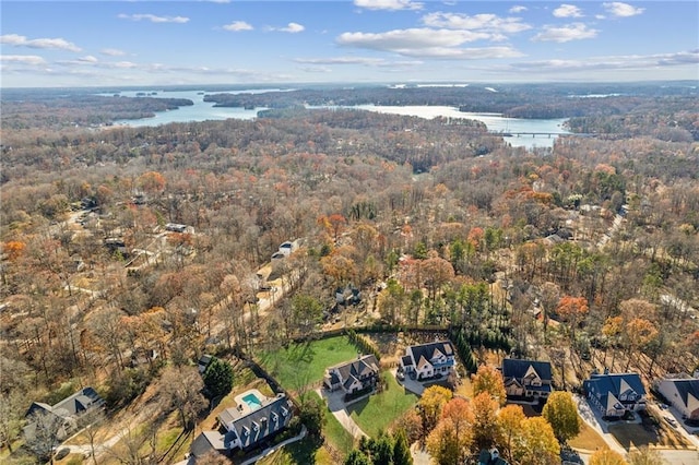 aerial view featuring a forest view and a water view