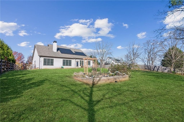 view of yard featuring a garden and a fenced backyard