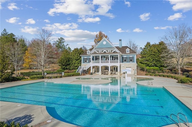 pool featuring stairway and a patio