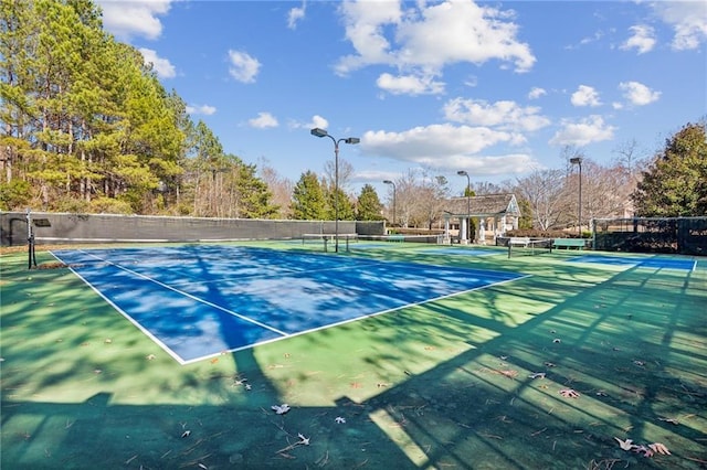 view of sport court featuring fence