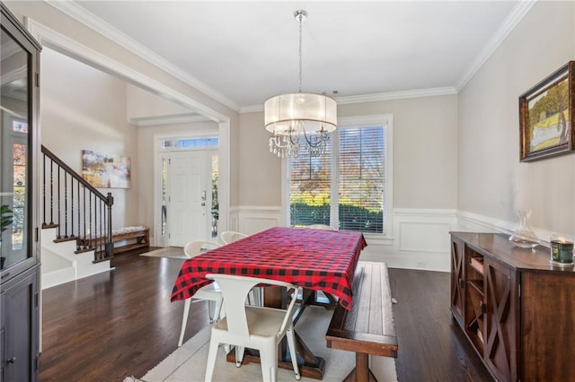 dining area with stairs, dark wood finished floors, crown molding, and wainscoting