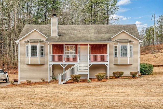 raised ranch with a front lawn and covered porch