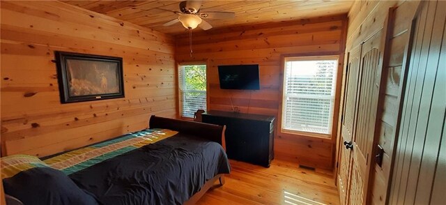 1251 Bar T Ranch Rd, Talking Rock, GA 30175 - bedroom with wood walls, light hardwood / wood-style flooring, ceiling fan, and wooden ceiling