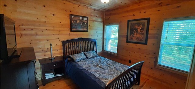 1251 Bar T Ranch Rd, Talking Rock, GA 30175 - bedroom featuring hardwood / wood-style flooring, wood walls, and multiple windows