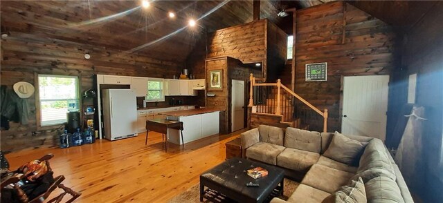 1251 Bar T Ranch Rd, Talking Rock, GA 30175 - living room featuring high vaulted ceiling, light hardwood / wood-style flooring, and wood walls