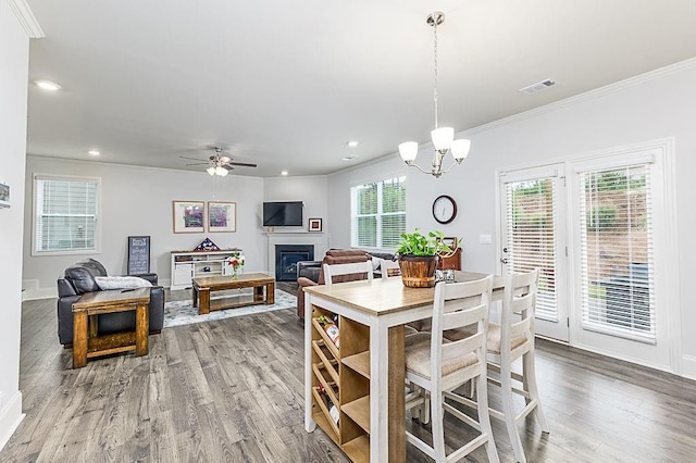 895 Garnet Dr, Acworth, GA 30101 - dining space with ornamental molding, wood finished floors, recessed lighting, a glass covered fireplace, and a ceiling fan
