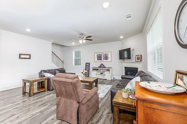 895 Garnet Dr, Acworth, GA 30101 - living room with stairs, crown molding, plenty of natural light, recessed lighting, and a glass covered fireplace