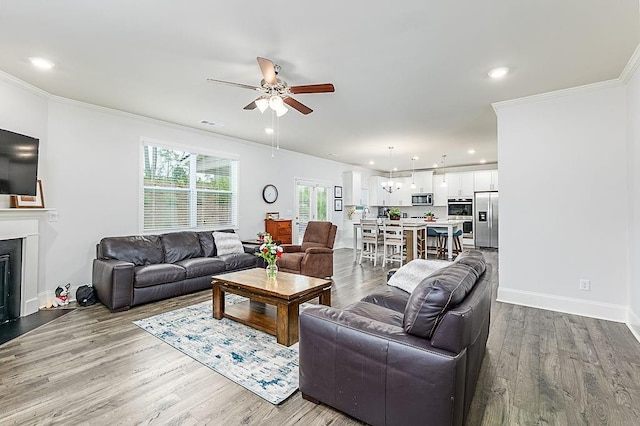 895 Garnet Dr, Acworth, GA 30101 - living area featuring a ceiling fan, wood finished floors, crown molding, a fireplace, and recessed lighting