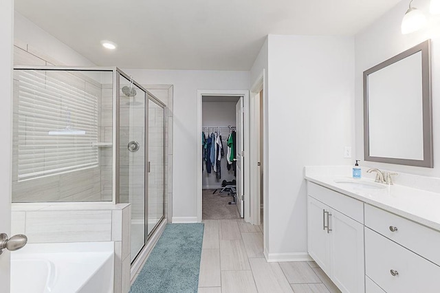 895 Garnet Dr, Acworth, GA 30101 - bathroom featuring a shower stall, vanity, a bath, a spacious closet, and recessed lighting