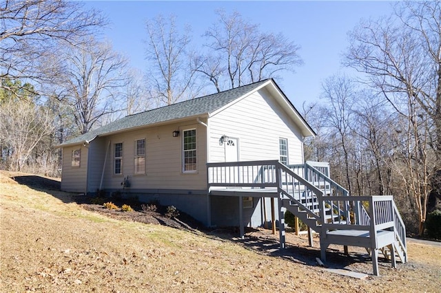 view of property exterior featuring a wooden deck