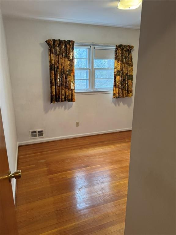 unfurnished room featuring hardwood / wood-style flooring