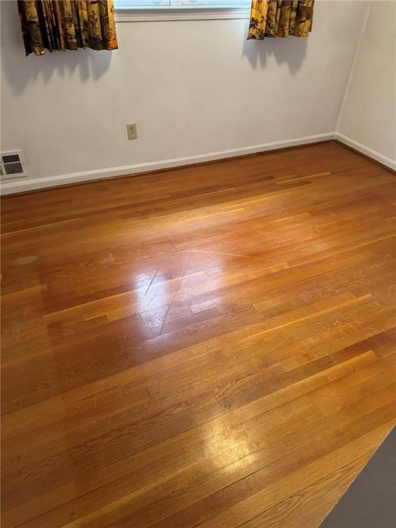 empty room with wood-type flooring