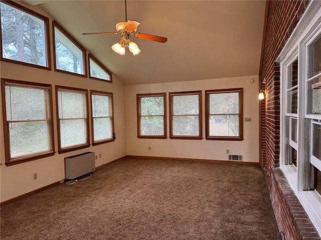 carpeted empty room with ceiling fan, radiator heating unit, and high vaulted ceiling