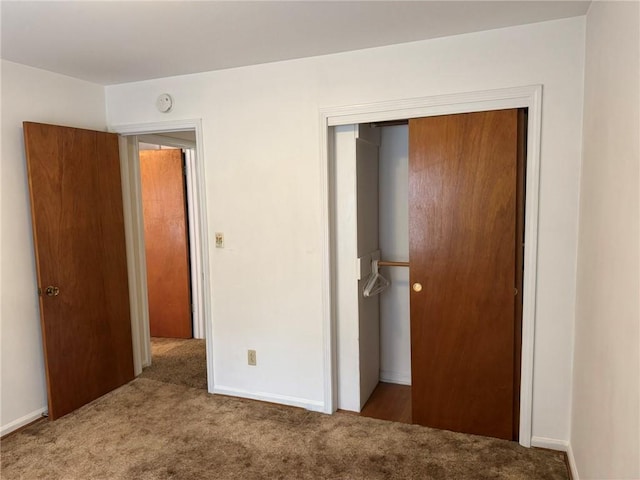 unfurnished bedroom featuring carpet floors and a closet