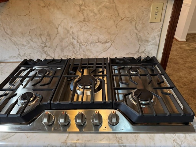 room details featuring gas cooktop and carpet