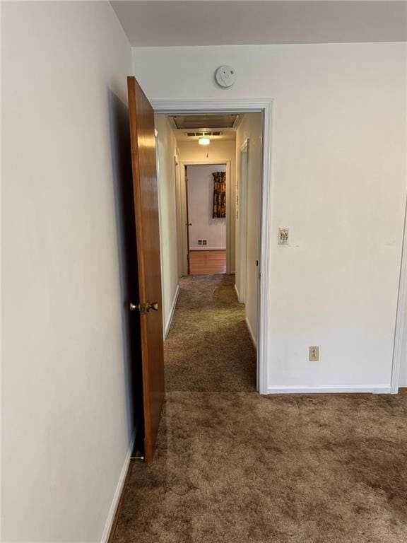 hallway featuring dark carpet