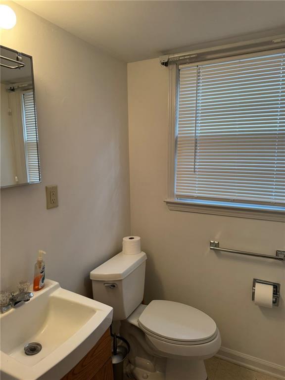 bathroom featuring tile patterned flooring, sink, and toilet