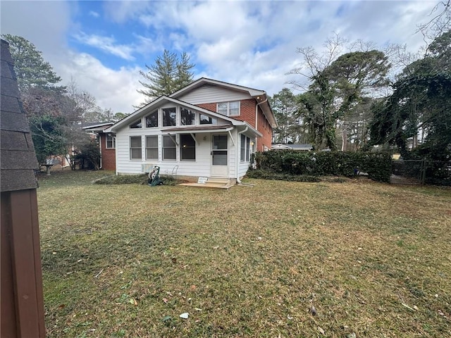 rear view of property featuring a yard