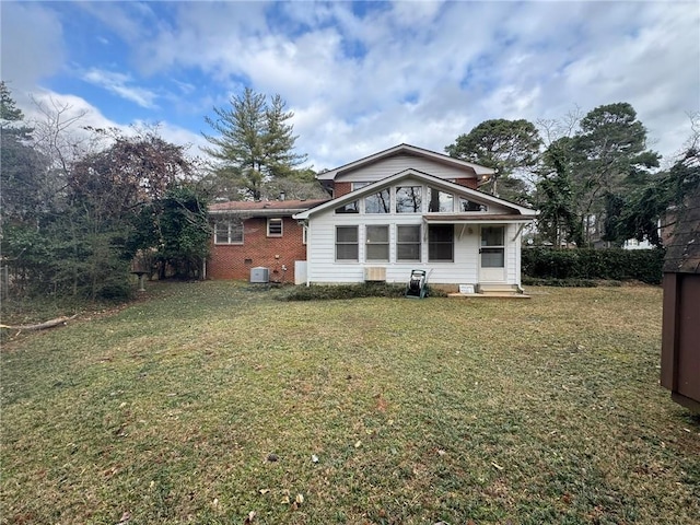 rear view of house featuring a lawn