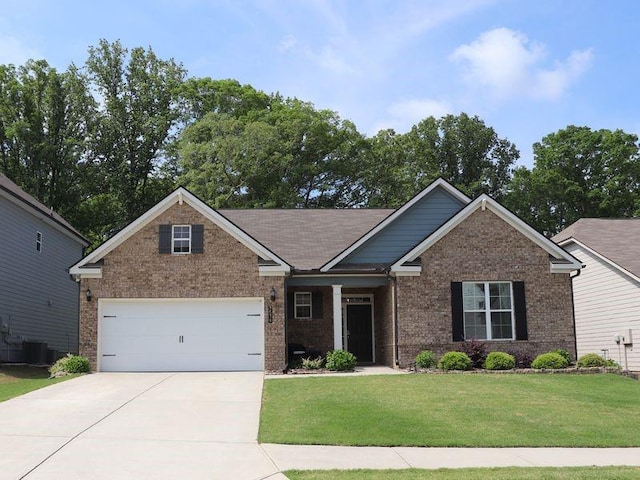 craftsman inspired home featuring an attached garage, concrete driveway, a front lawn, and brick siding