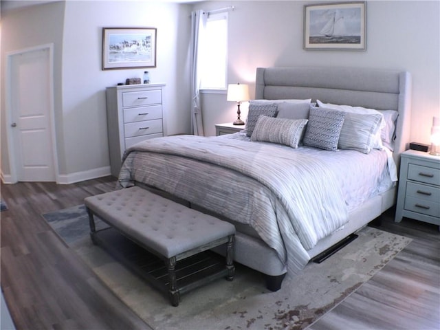 bedroom with baseboards and wood finished floors