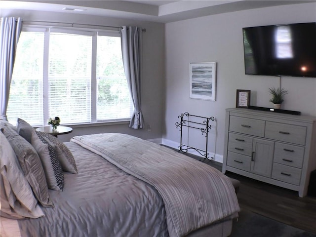 bedroom with baseboards and dark wood-style floors