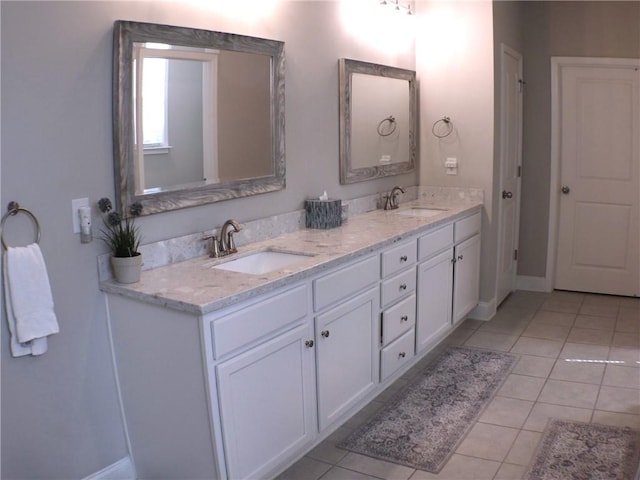 full bath with a sink, baseboards, and tile patterned floors