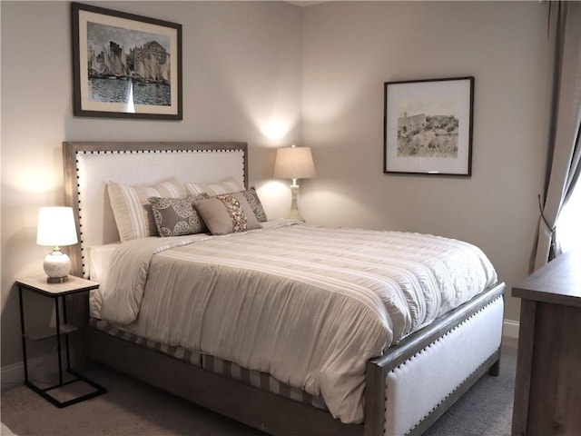 carpeted bedroom featuring baseboards